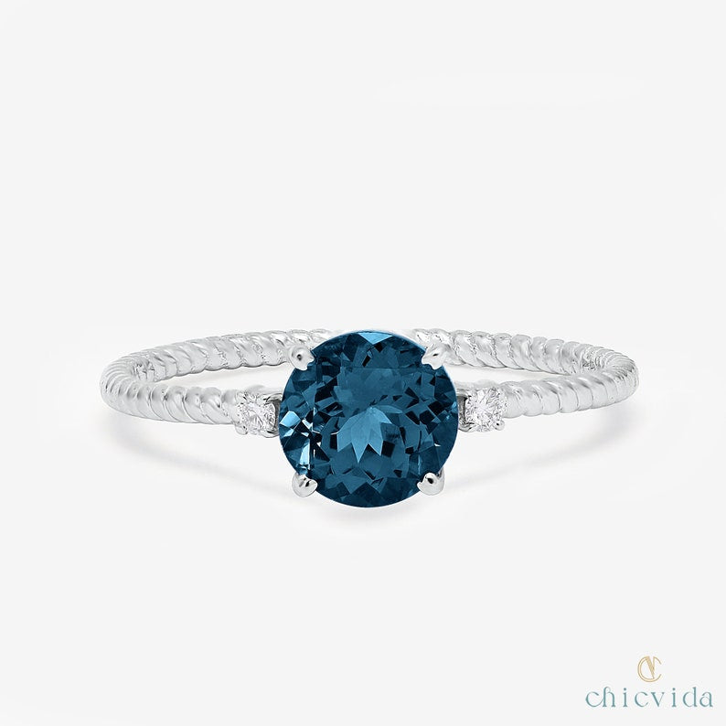 Handcrafted gold ring featuring London Blue Topaz center stone