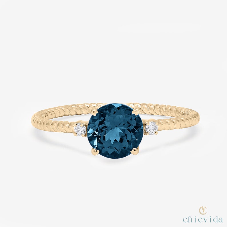 14k gold twisted band ring with London Blue Topaz and diamonds