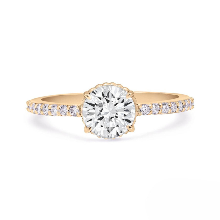 Round moissanite solitaire ring with pavé diamond band in yellow gold