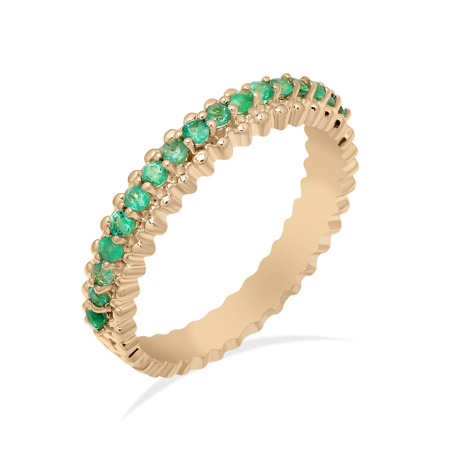 Handcrafted beaded gold ring featuring round-cut green emeralds