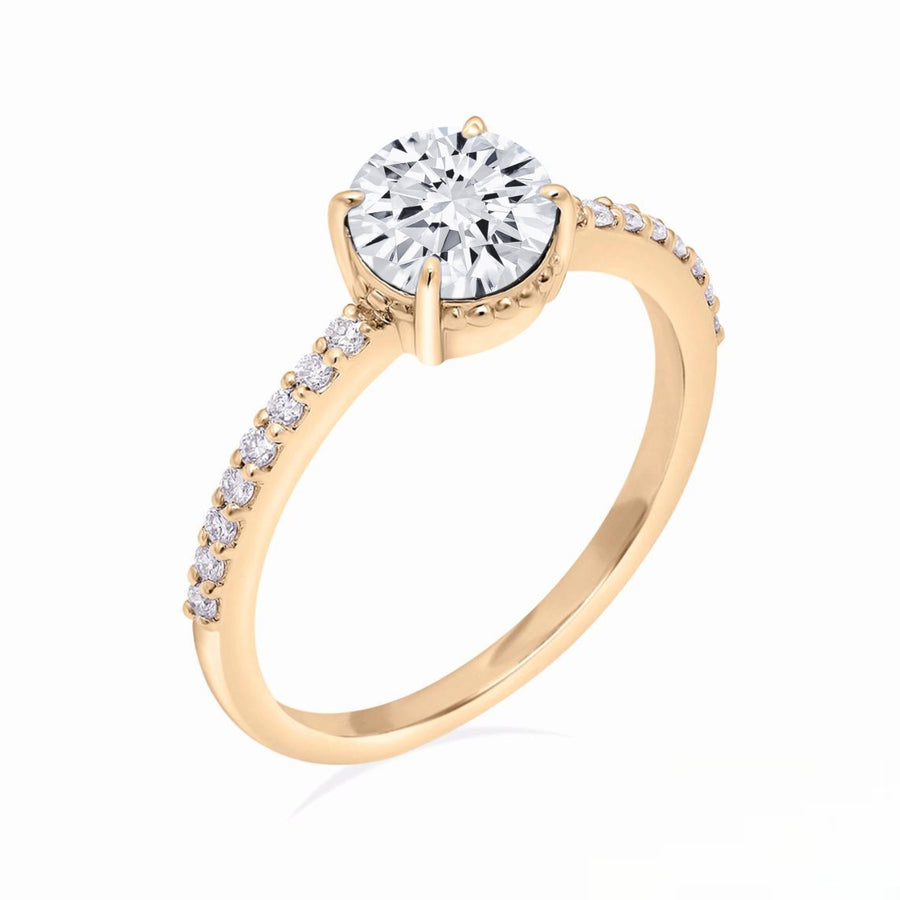 Prong proposal ring with moissanite center and gold pavé band