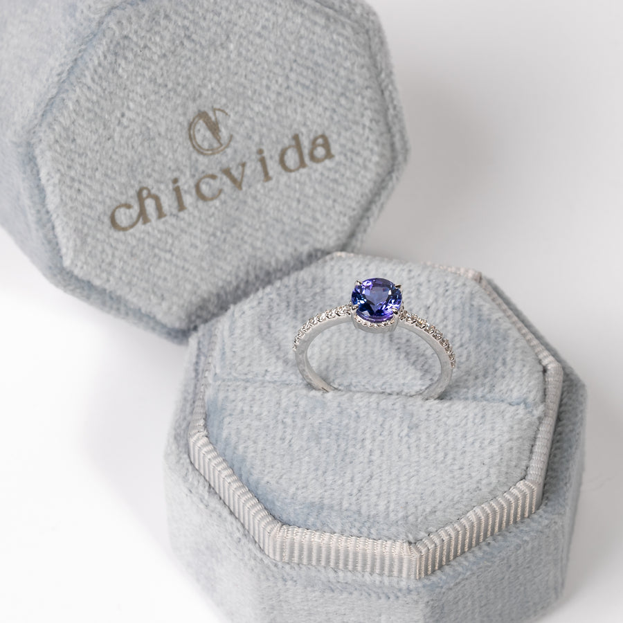 Dainty prong set engagement ring with tanzanite and diamond accents