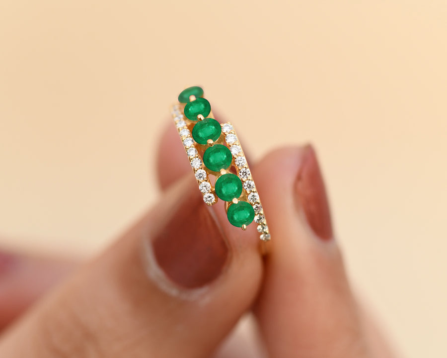 May birthstone emerald ring with pavé diamond bands