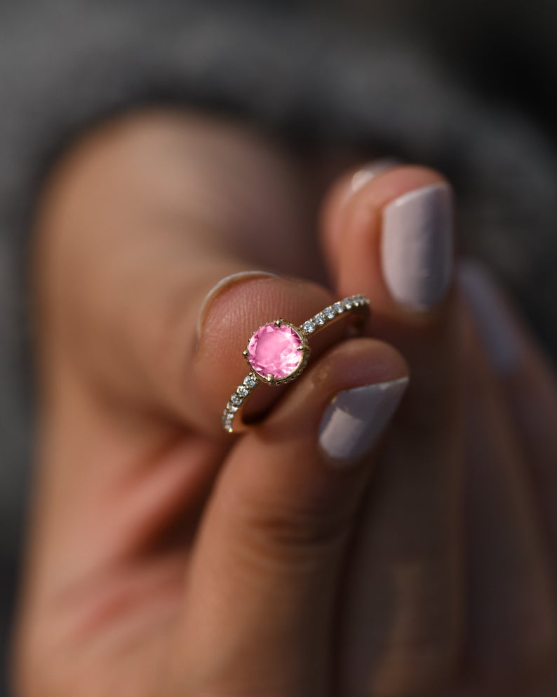 Pink tourmaline proposal ring with pavé diamonds and gold band